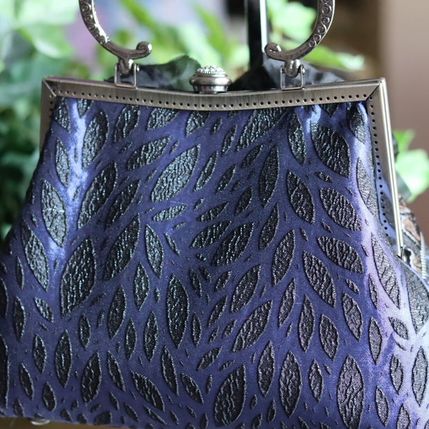Black Silk Flower and Blue Handbag